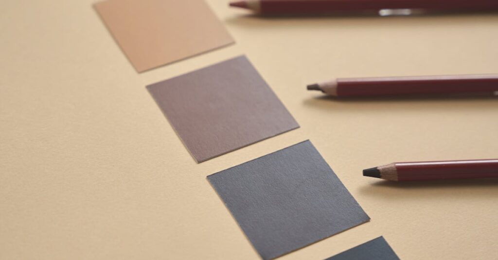 Arrangement of pencils and color samples on a beige background, perfect for design inspiration.